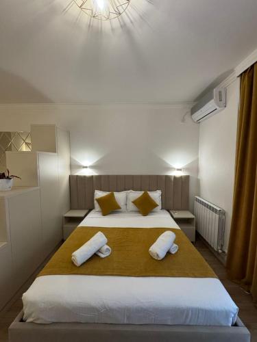 a bedroom with a large bed with two towels on it at Moonlight Apart-Hotel Batumi in Batumi