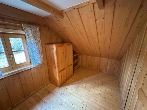 an empty room in a log cabin with a window at Pension Tereza & Šumavské Roubenky in Sušice