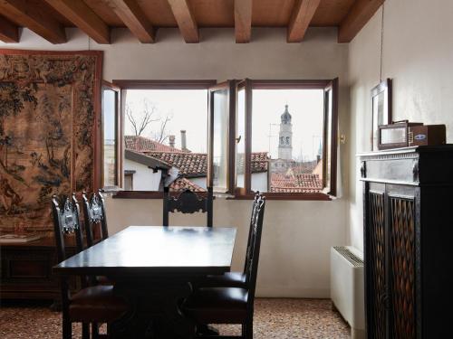 a dining room with a table and a view of a building at Palazzo Contarini Della Porta Di Ferro in Venice