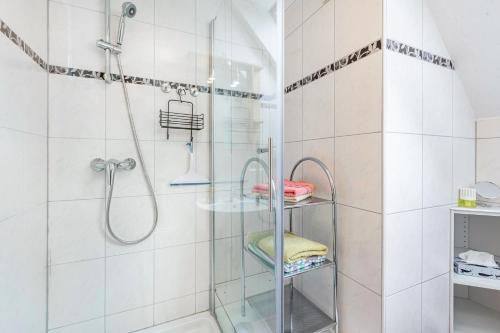 a bathroom with a shower with a glass shelf at Drei Tannen in Todtnau
