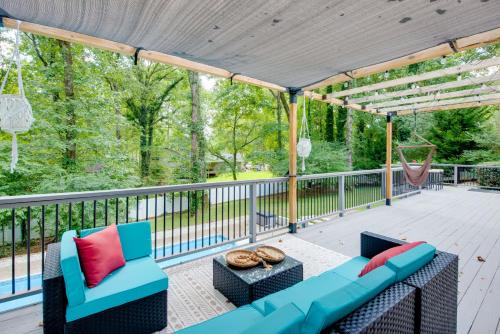 a patio with a blue couch and chairs and a table at Mableton Home with Private Pool about 15 Mi to ATL! in Mableton