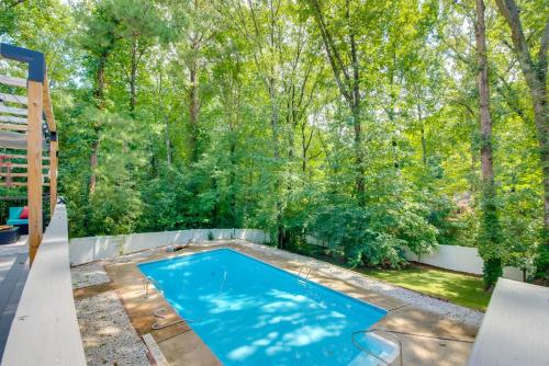 a swimming pool in the middle of a yard with trees at Mableton Home with Private Pool about 15 Mi to ATL! in Mableton