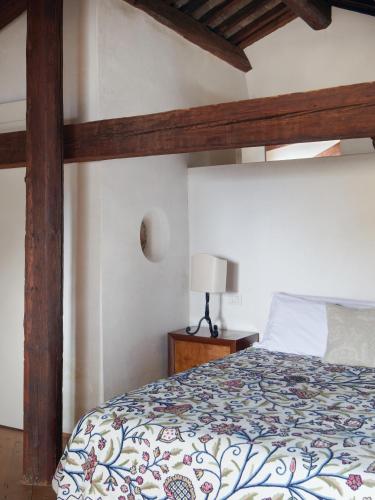 a bedroom with a large bed with a wooden frame at Palazzo Contarini Della Porta Di Ferro in Venice