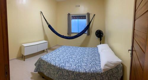 a bedroom with a bed with a hammock in it at Nova casa de praia na Caponga in Cascavel