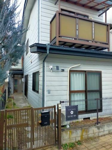 a house with a sign in front of it at Sakura in Matsumoto