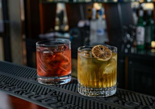 two cocktails sitting on a shelf in a bar at Swiss-Belhotel Seef Bahrain in Manama