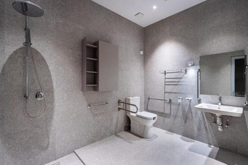 a bathroom with a toilet and a sink and a shower at Old Theatre Suites - Montecristo in Valletta