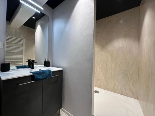 a bathroom with a sink and a mirror at B'm Hans - Centre Historique - Vue Cathédrale - 2P in Colmar