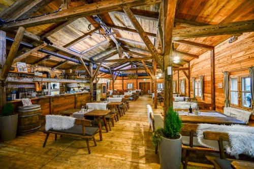 a restaurant with wooden walls and tables and chairs at Das ACKER Hotel in Neuburg an der Donau
