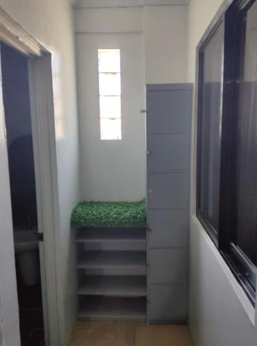 a hallway with a stairway with a window and a window at Eddie's Value Room for Practical Group Stay in downtown San Fernando in San Fernando