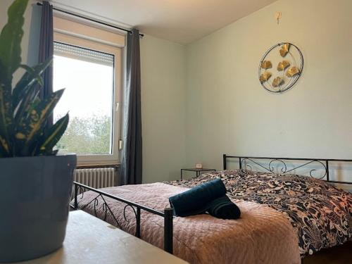 a bedroom with a bed with a plant on a table at 1er etage entier, 2 Appartements, 10 Pers in Delle