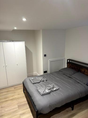 a bedroom with a bed with tongs on it at Modern 2-Bed Flat in Euston in London