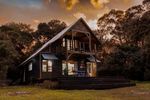 a small house with a gambrel roof at Rockwood Karkloof Forest Lodge & Mountain Cabin in Karkloof Nature Reserve