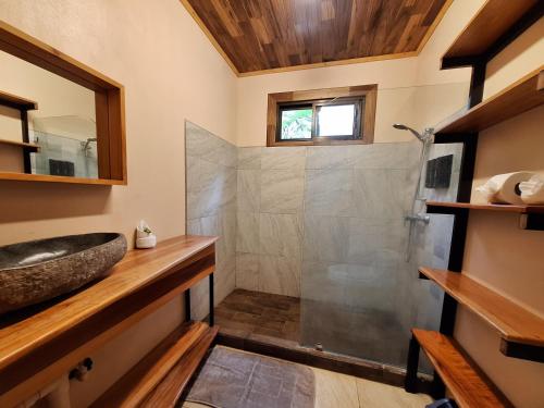 a bathroom with a sink and a shower at Eco Villas-Houses-Tents Corcovado-Mountain-Ocean Views in Puerto Jiménez