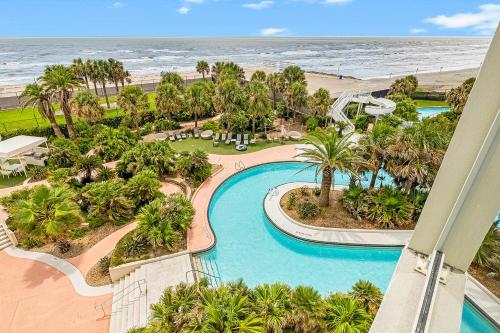an aerial view of the pool and the beach at Diamond Beach Resort - Lazy River View #419 in Galveston