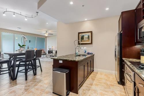 a kitchen with a counter and a dining room at Diamond Beach Resort - Lazy River View #419 in Galveston