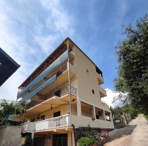 a building with balconies on the side of it at Apartments Dalmatin in Žuljana