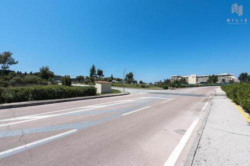 an empty road with buildings in the distance at Porto Karras Private Rental, Nilie Hospitality MGMT in Neos Marmaras