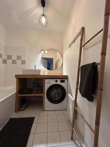 a washing machine in a bathroom with a mirror at F3 Central, Bright and Quiet in Caen in Caen