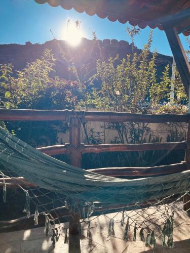 a hammock with the sun in the background at Pousada Recanto da Chapada in Mucugê