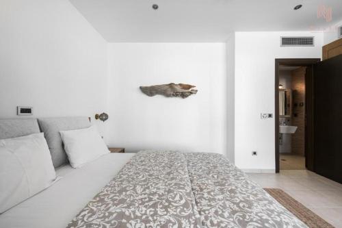 a white bedroom with a large bed in it at Porto Karras Private Rental, Nilie Hospitality MGMT in Neos Marmaras