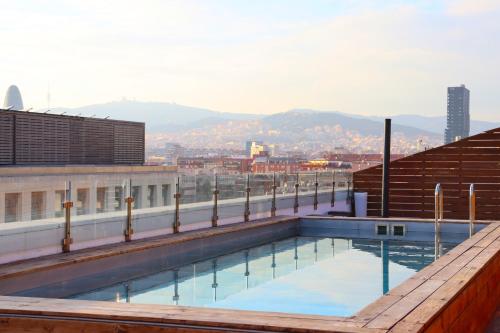 a swimming pool on the roof of a building at Eurohotel Diagonal Port in Barcelona