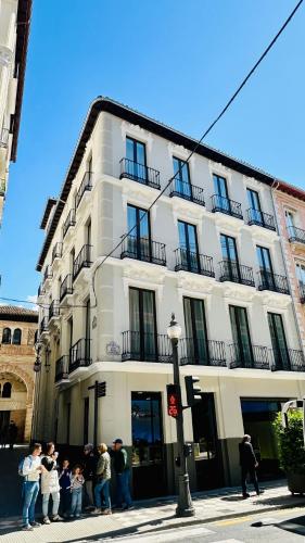 a group of people standing in front of a building at Corral del Carbón GG Luxury Hotel Boutique in Granada