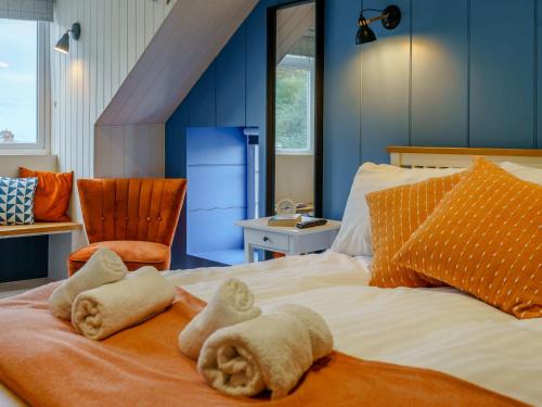 a bedroom with a bed with towels on it at 3 Bed in New Quay 83998 in New Quay