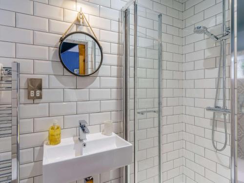a white bathroom with a sink and a mirror at 3 Bed in New Quay 83998 in New Quay