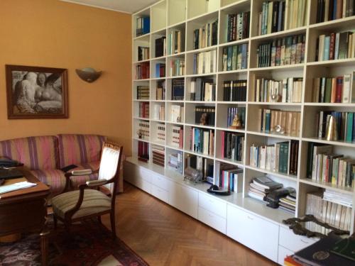 a room with a large book shelf filled with books at La Gaura Guest House in Casal Palocco
