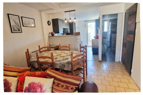 une cuisine et une salle à manger avec une table et des chaises dans l'établissement L'Iranget, maison de vacances 6 pers à 100 mètres des plages de Valras-Plage, à Valras-Plage