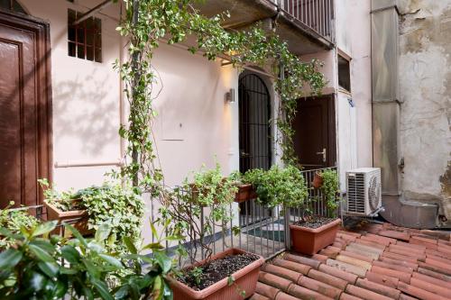 a patio with potted plants on a building at Emme Loft I New Moon - Stylish Apartment with Balcony in Milan