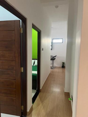 a hallway with a door and a desk in a room at Wilson's Guest House in Nilwella