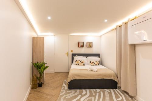 a bedroom with a bed with two dogs on it at Modern Souplex with Air Conditioning and Hot Tub I Central location in Paris