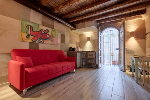 a living room with a red couch and a window at Emme Loft I New Moon - Stylish Apartment with Balcony in Milan