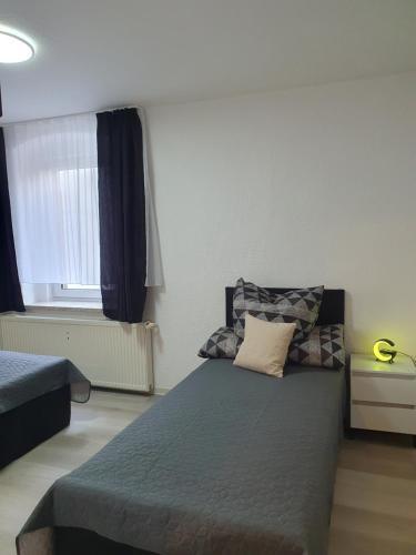 a small bedroom with a bed and a window at Pension Valentina in Mühlau