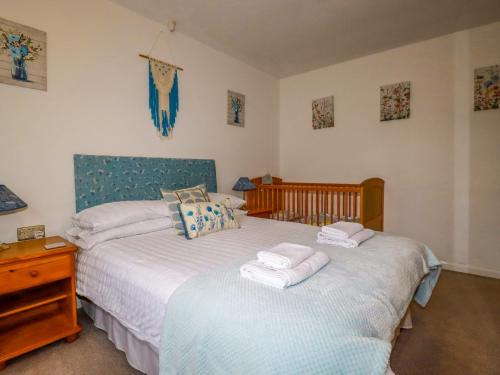 a bedroom with two beds and a dresser with towels at Tataramoa in Penryn