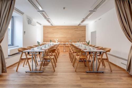 a large room with a long table and chairs at Hotel Golfi in Poděbrady