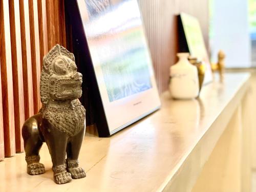 a statue of a dog sitting on a shelf at SKY VILLA - BKK Phnom Penh - Rooms & Apartments - FREE LAUNDRY in Phnom Penh