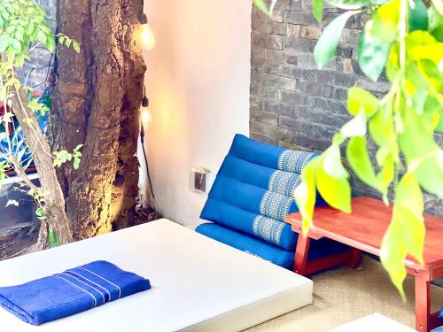 a bench next to a table and a tree at SKY VILLA - BKK Phnom Penh - Rooms & Apartments - FREE LAUNDRY in Phnom Penh