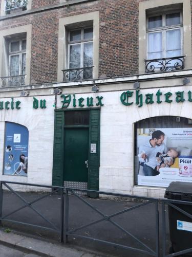 a building with a sign on the side of it at Le petit dieppois in Dieppe