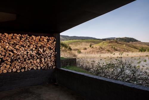 a pile of fire wood sitting next to a wall at Rockwood Karkloof Forest Lodge & Mountain Cabin in Karkloof Nature Reserve