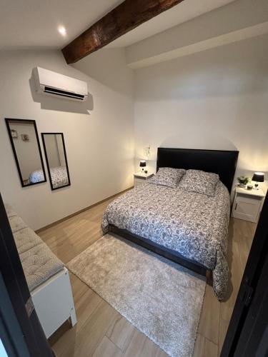 a bedroom with a bed and two night stands at Le ST PIERRE, joli T2 entièrement rénové en plein coeur du centre ville in Mâcon