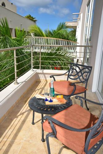 two chairs and a table on a balcony at Oceanfront Paradise: Penthouse with Peloton in Lowlands