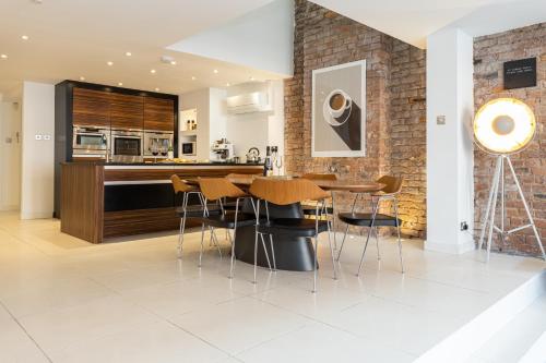 a kitchen and dining room with a table and chairs at Luxury Penthouse with Private Roof Terrace in Manchester