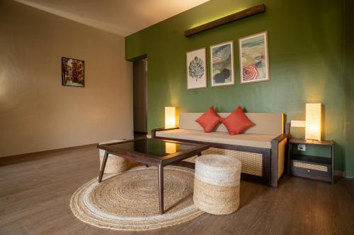 a living room with a couch and a coffee table at Kssemya in Mandrem