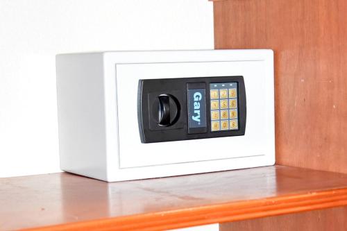 a digital clock on top of a wooden shelf at Oceanfront Paradise: Penthouse with Peloton in Lowlands