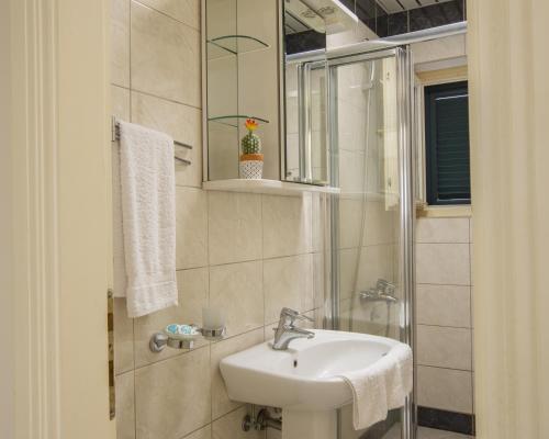 a bathroom with a sink and a mirror at Montesan Luxury Apartments Sveti Stefan in Sveti Stefan