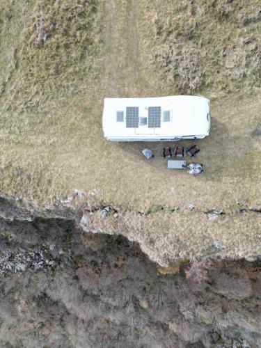 an aerial view of a white building in a field at Элитный автодом для семьи in Tbilisi City
