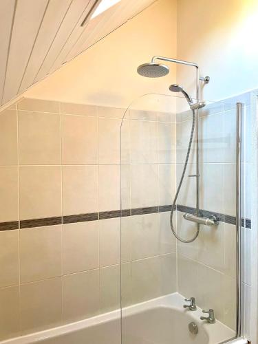 a bathroom with a shower and a sink at Medway Hot Tub Lodge in South Cerney